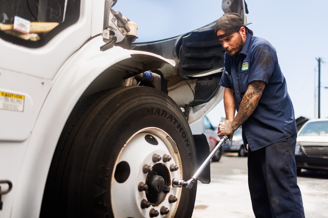Technician working on commercial truck wheel
